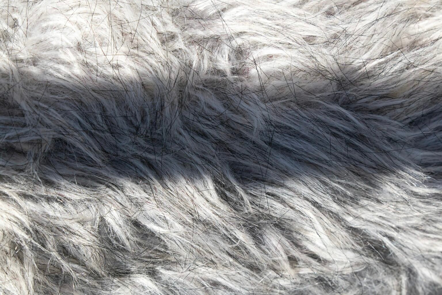 Close-up of long gray shag pile, the texture you protect when you learn how to keep a shaggy rug fluffy