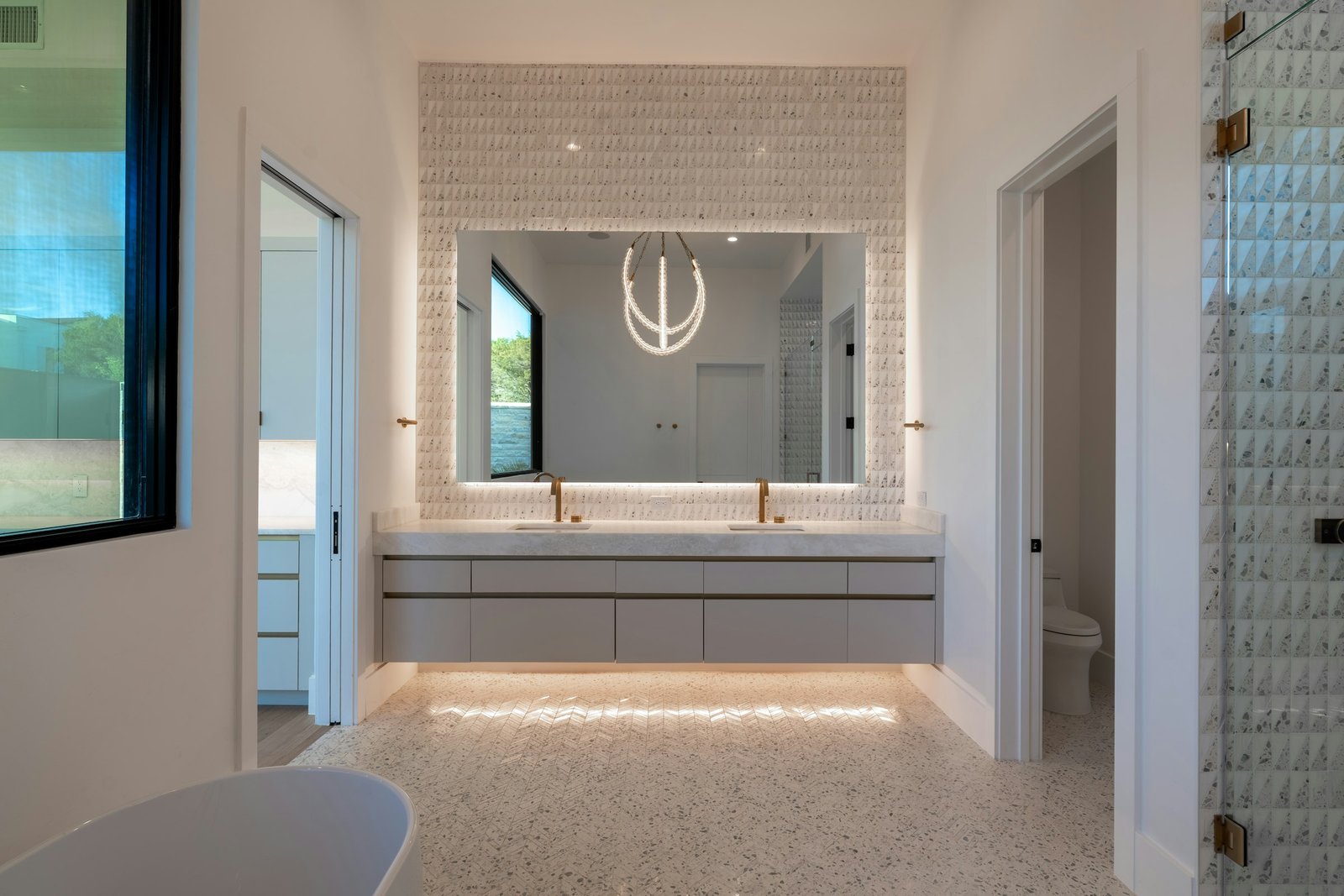 Anti fog LED bathroom mirror idea: a large backlit rectangular mirror over a floating double vanity in a bright bathroom