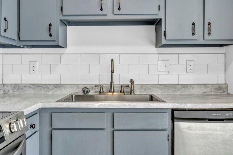 Backsplash installation cost: white subway tile behind a kitchen sink