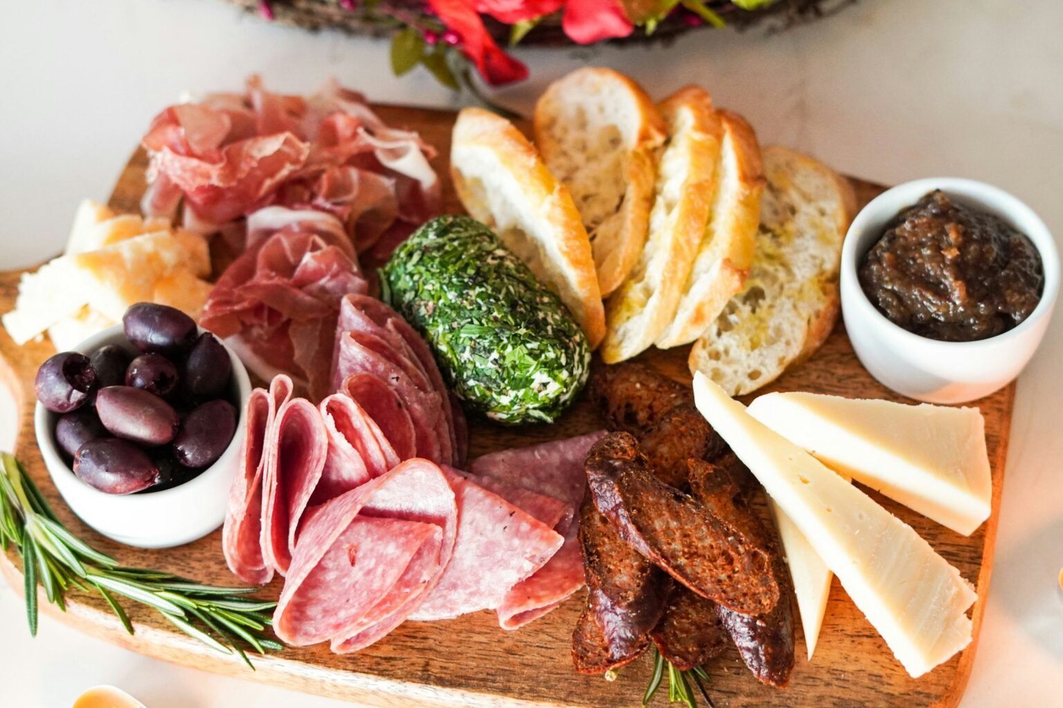 Meat, bread and vegetables served on a wooden board from a bamboo cutting board set