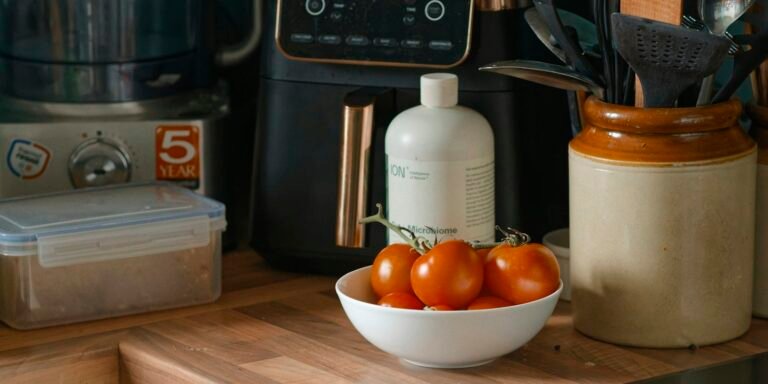 Best air fryer for family meals on a wooden kitchen counter next to fresh tomatoes