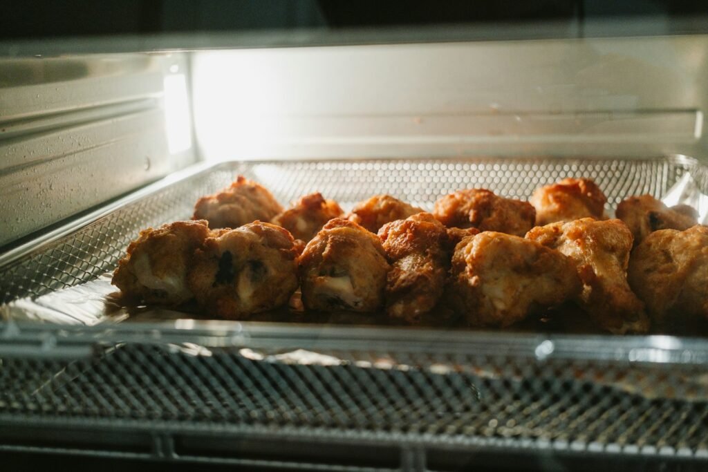 Crispy chicken pieces cooking in a best family size air fryer