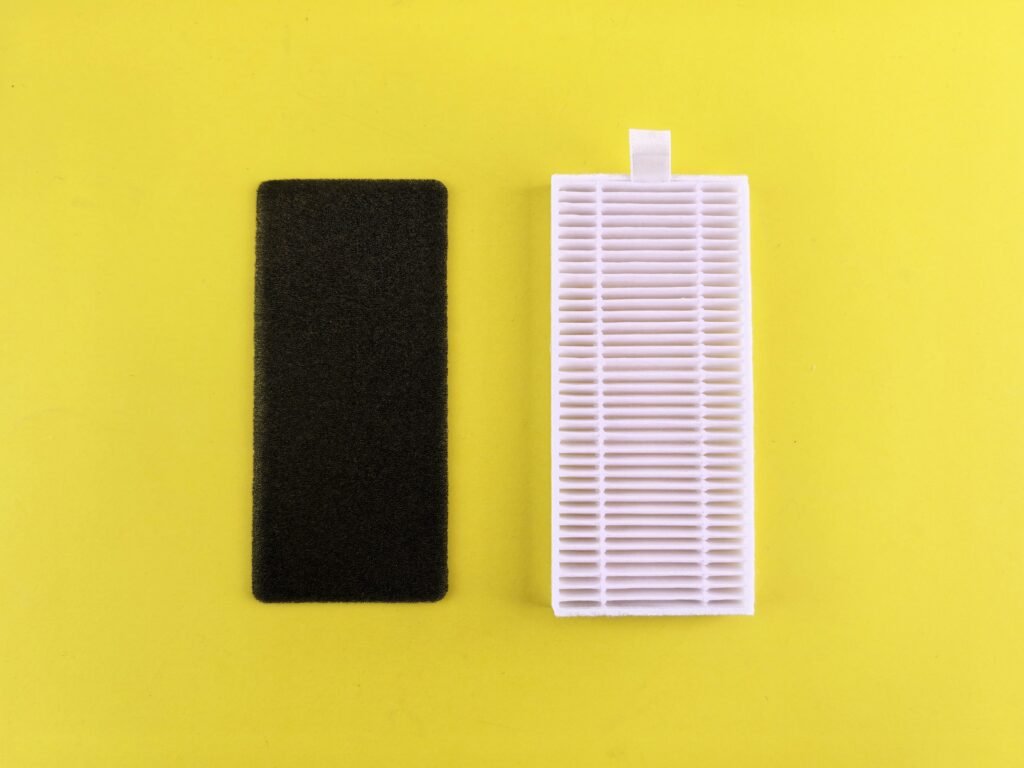 Best HEPA air purifier for bedroom maintenance: a pleated HEPA filter beside a black carbon pre-filter