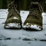 Snow-covered winter boots on a snowy deck, the wet mess the best boot tray for winter is made to catch
