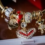 Gold charm bracelet with heart, teddy bear and tree of life charms, an example of the best charm bracelet for women