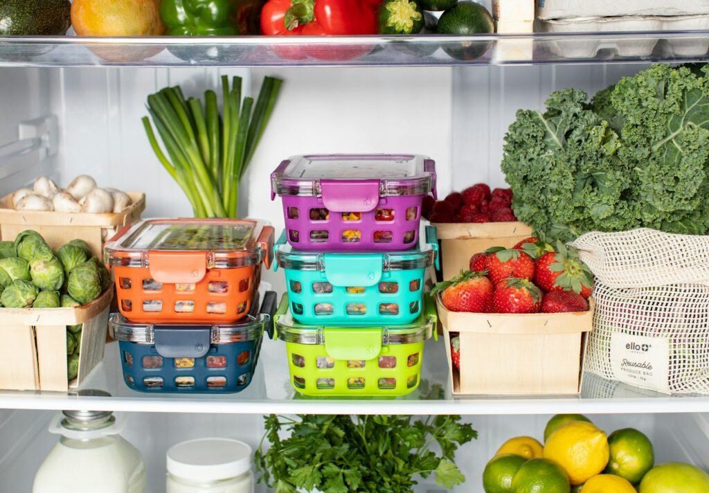 How to organize a chest freezer: stacked, color-coded food containers sorted by category
