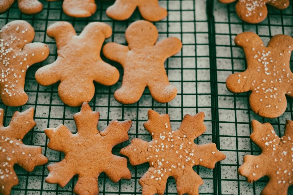 How to use a cookie press for spritz cookies and cut-outs: holiday cookies cooling on a wire rack