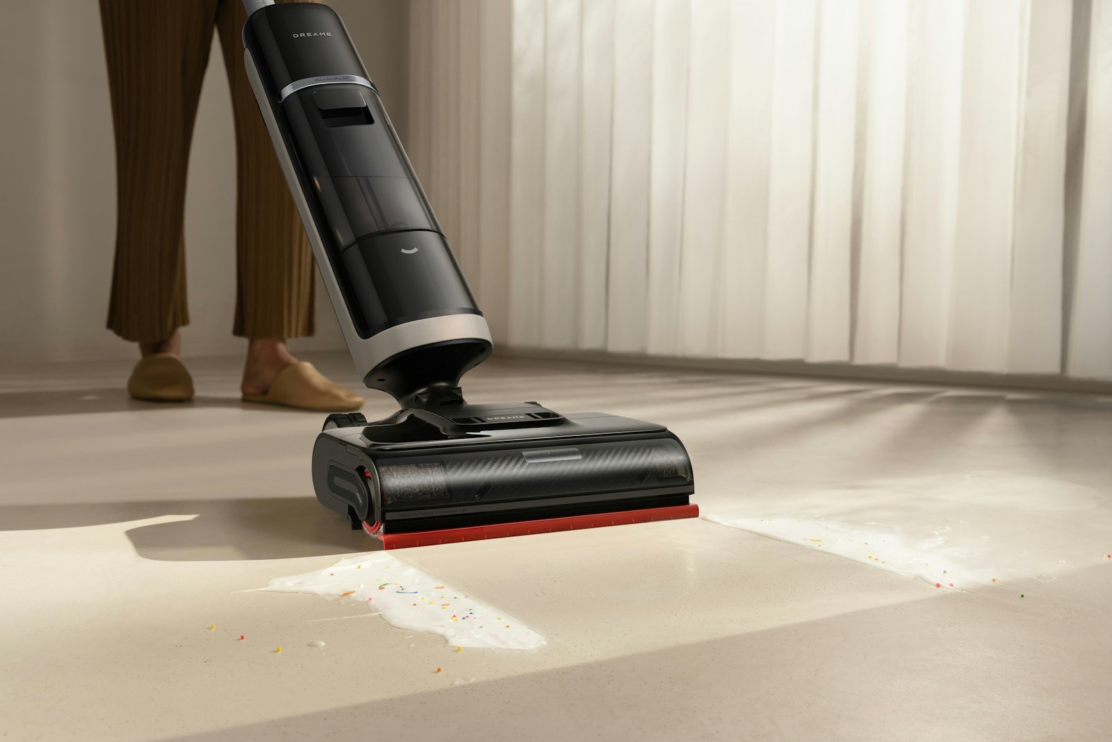 Best cordless vacuum under 300 dollars: a cordless stick vacuum cleaning a light floor in a sunny living room