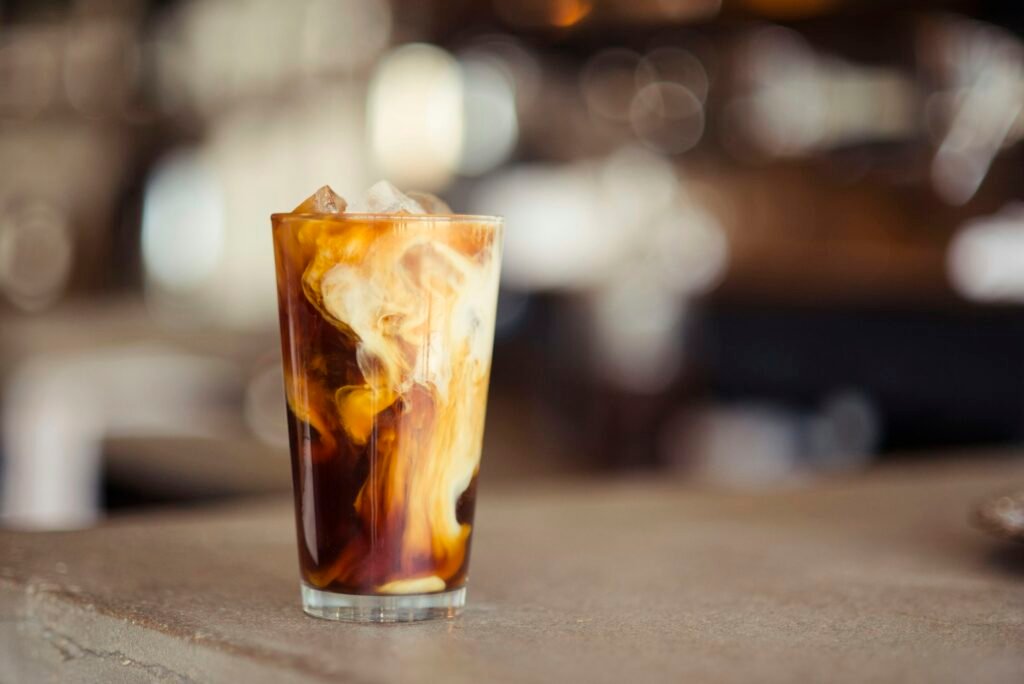 Best nugget ice maker drinks: iced coffee with milk over ice on a cafe counter