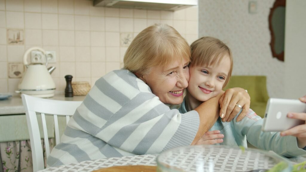 Grandmother and granddaughter taking a selfie to send to a Wi-Fi digital picture frame