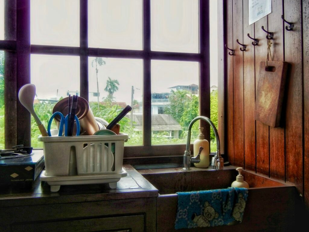 Dish drying rack for small spaces: a compact rack with a drainboard beside the kitchen sink