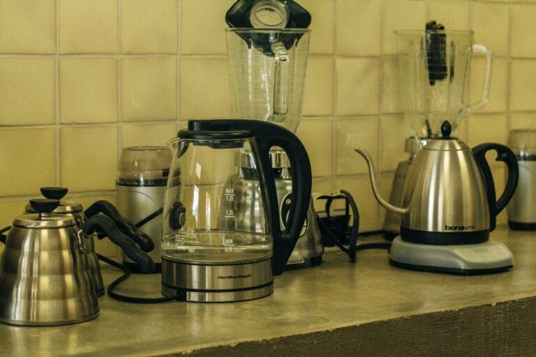 Best electric kettle options on a kitchen counter: a glass kettle, a gooseneck kettle and a stainless steel kettle