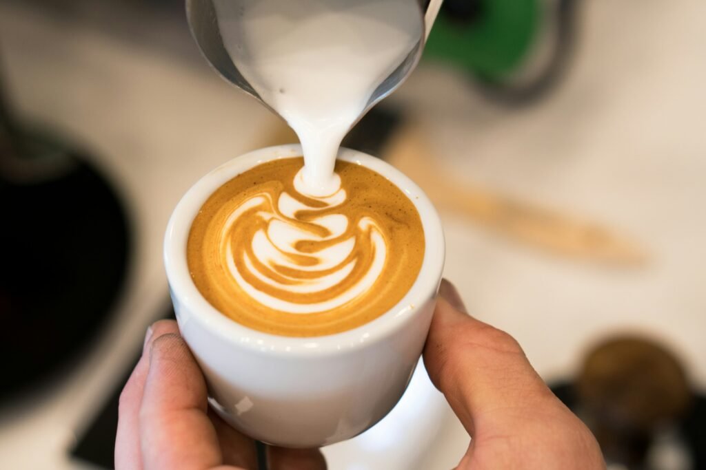 Steamed milk poured into a cappuccino, the drink a super automatic espresso machine makes at one touch
