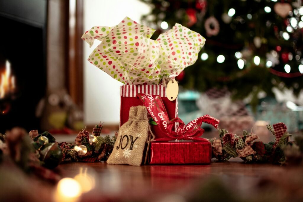 Wrapping paper storage for gift bags and tissue: a wrapped gift bag by a lit Christmas tree