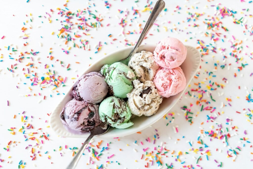 Best ice cream maker results: scoops of mint chip, berry and cookies and cream ice cream in a bowl with sprinkles