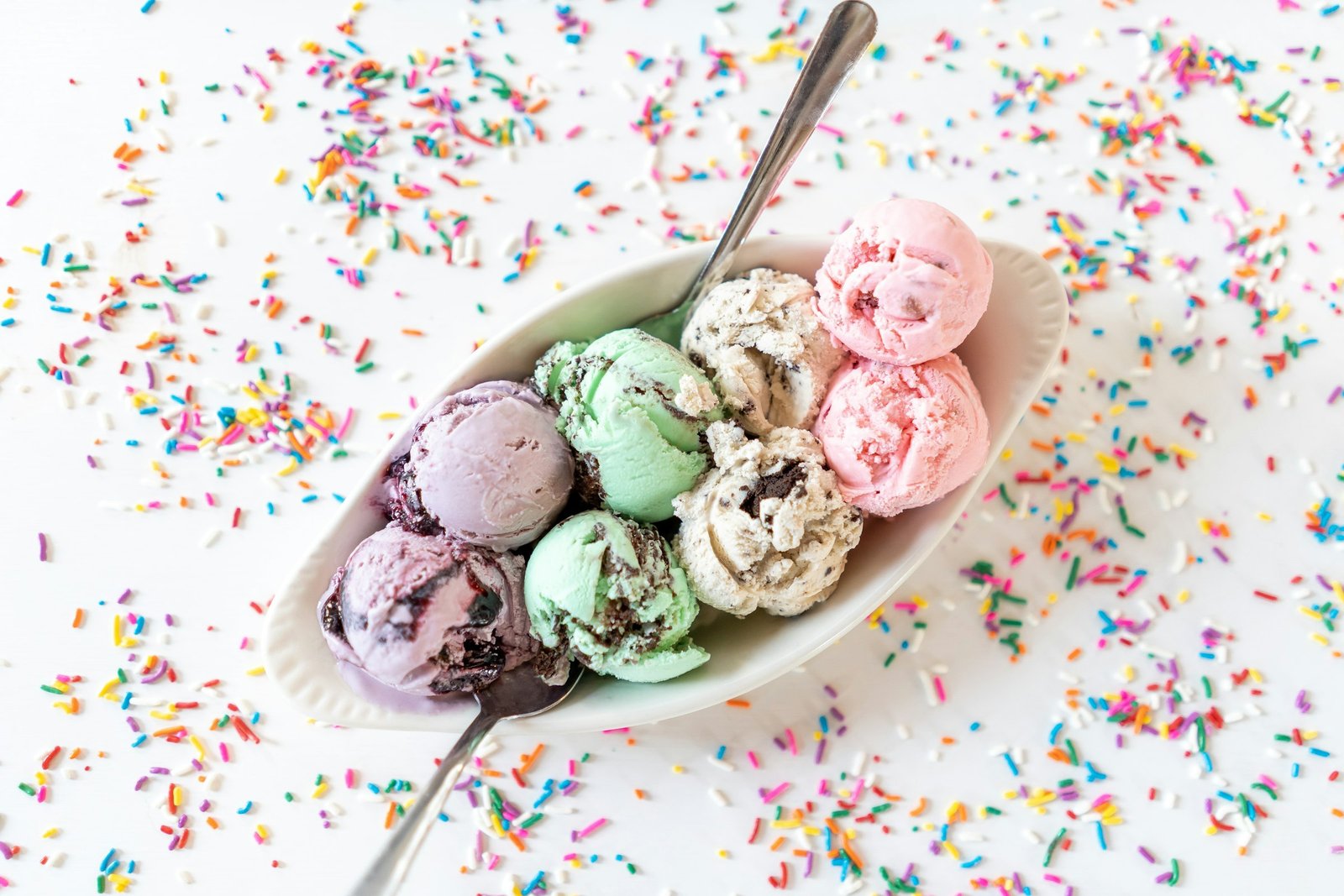 Best ice cream maker results: scoops of mint chip, berry and cookies and cream ice cream in a bowl with sprinkles