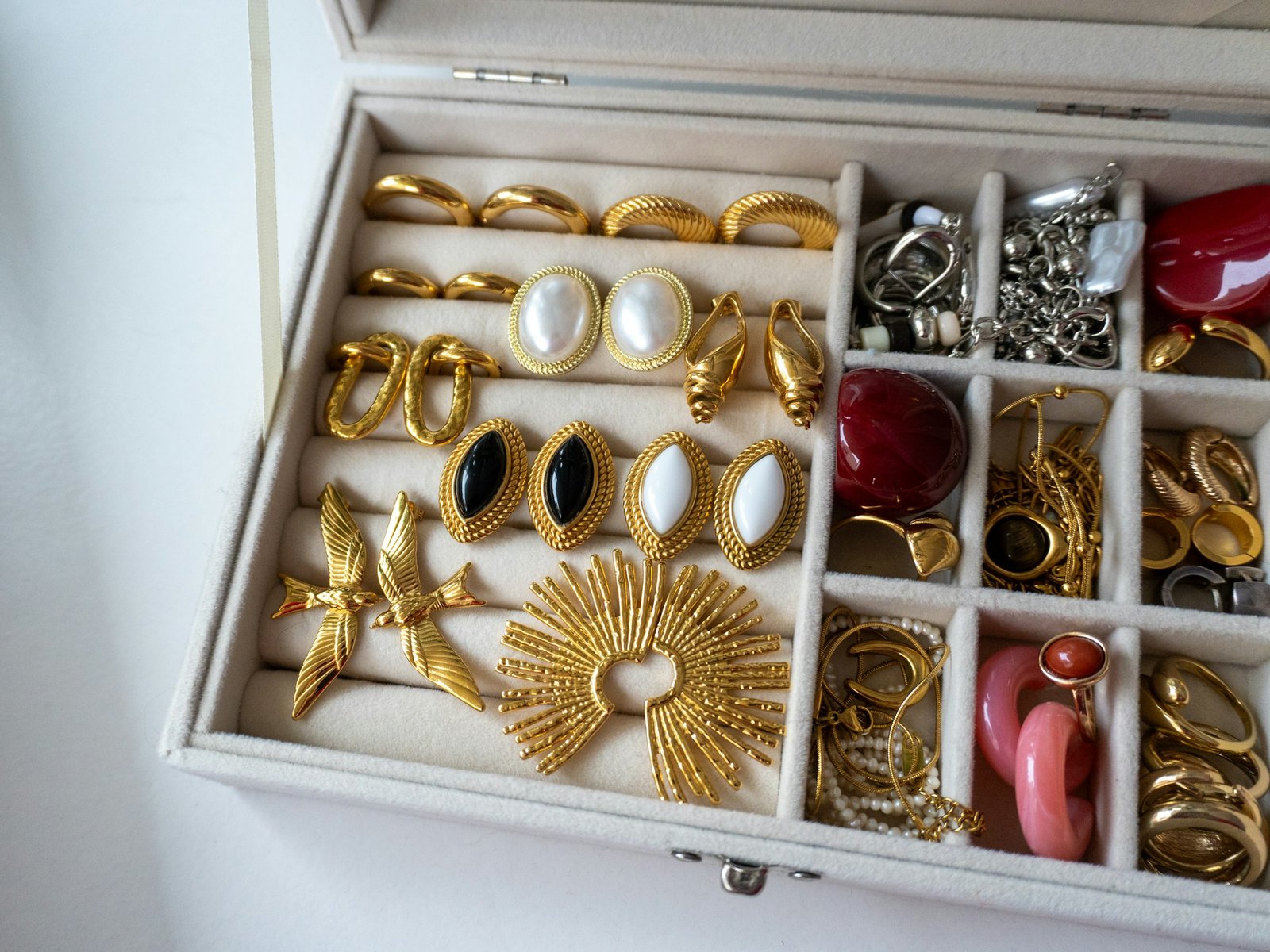 Best jewelry box with velvet ring rolls and compartments holding gold earrings and rings