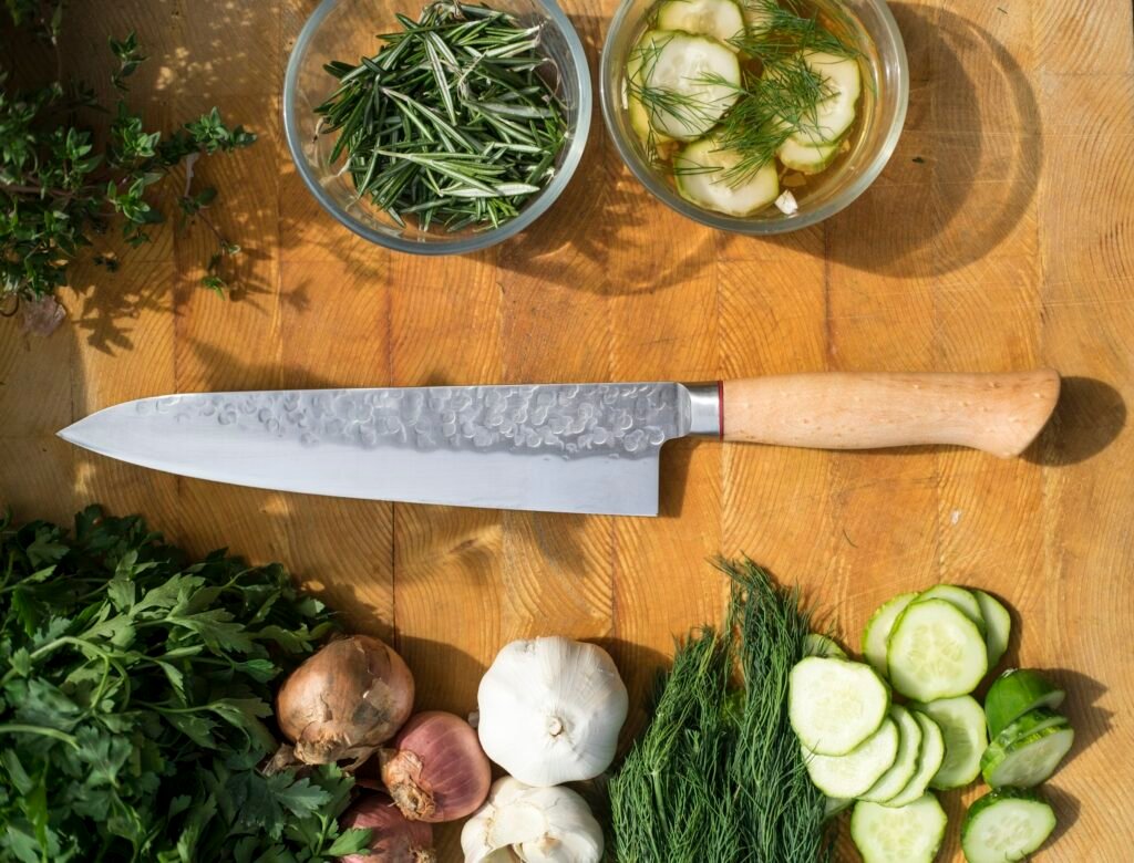Chef knife on a wooden board with herbs, the core blade in any knife block set with sharpener