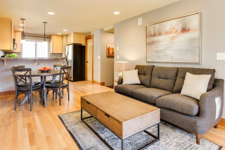 Lift top coffee table with storage drawers in front of a gray sofa in a small open-plan living room