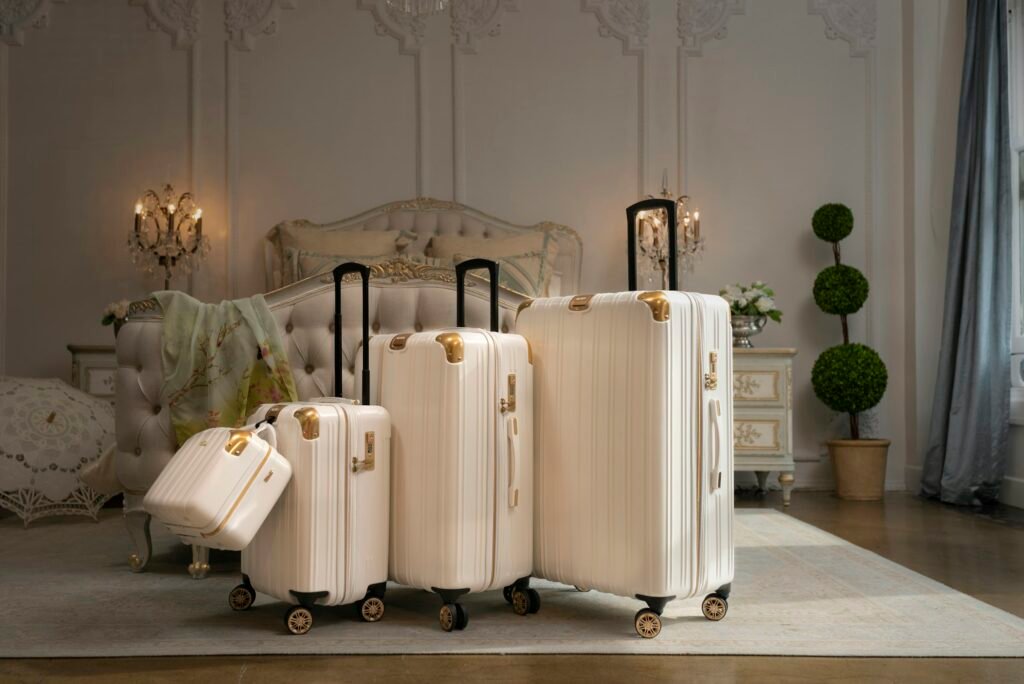 Best luggage sets for families: a cream 4-piece spinner luggage set with a vanity case in a bedroom