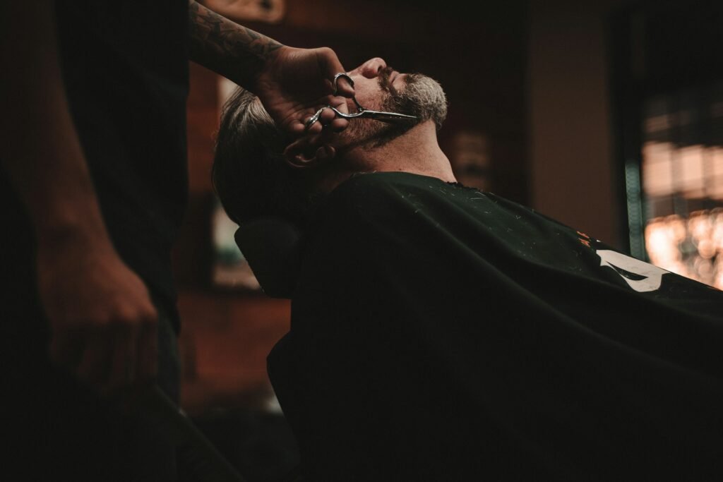 Luxury beard oil for men: a bearded man relaxing in a barber chair before grooming
