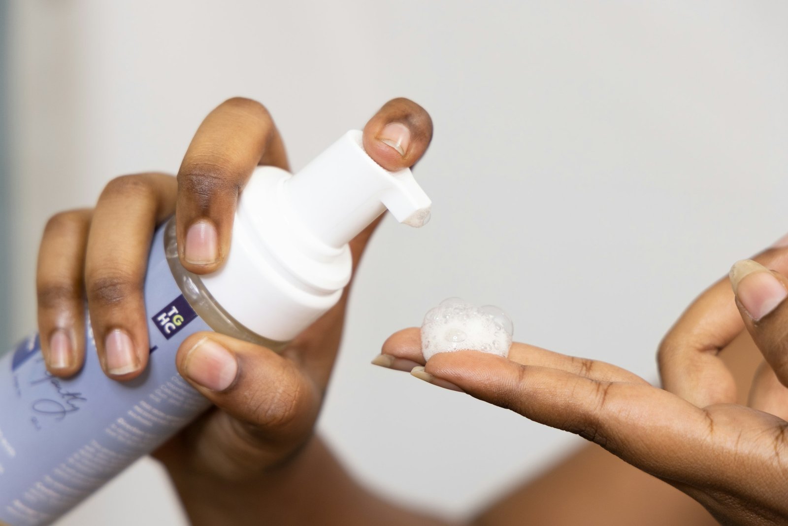 Luxury face wash: pumping a small amount of foam cleanser onto a fingertip