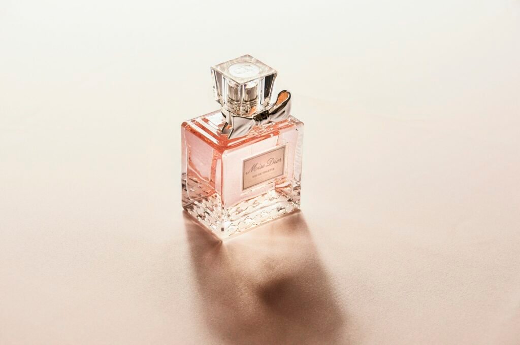 Luxury roll on perfume alternative: a glass perfume bottle on a soft blush vanity surface