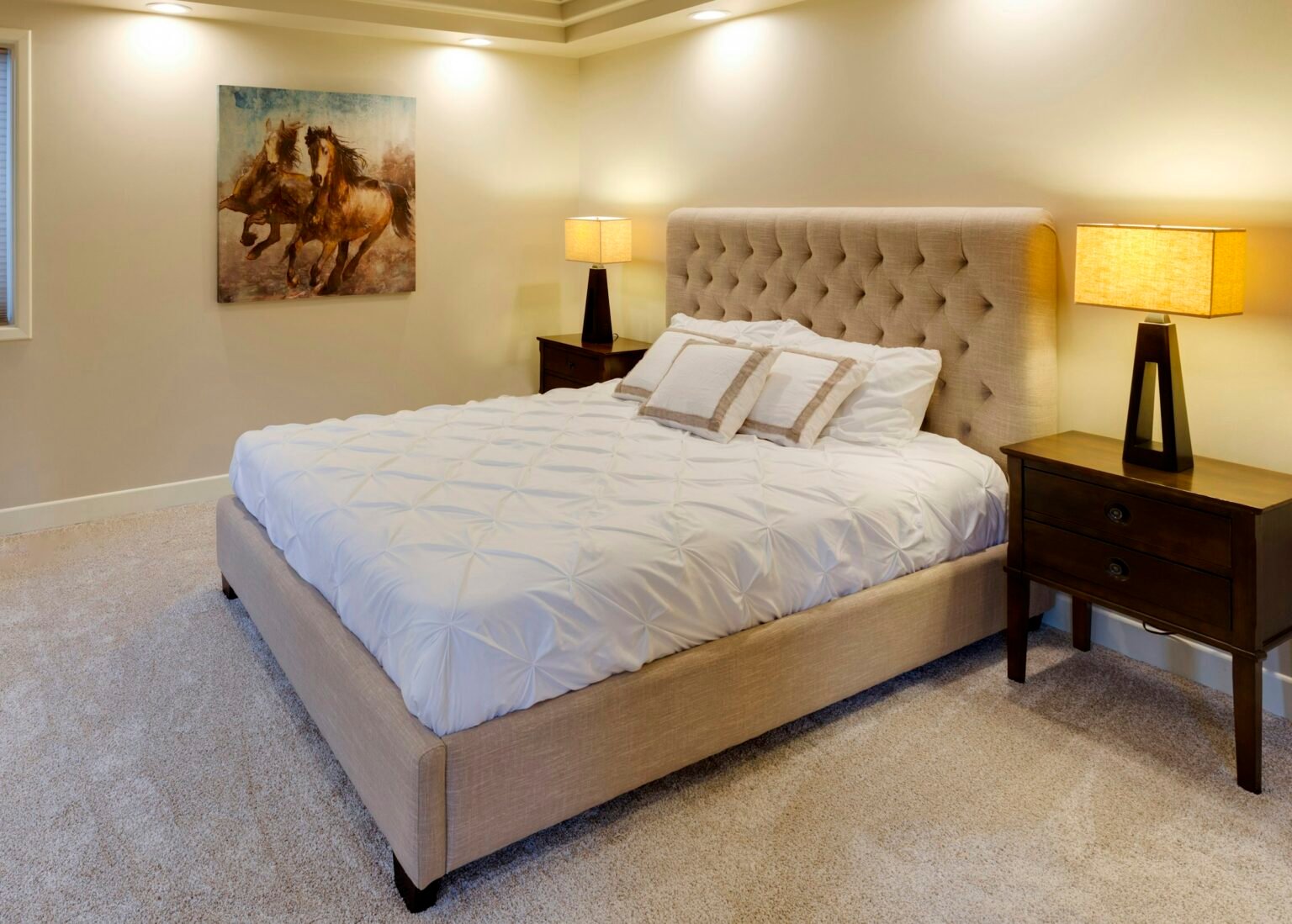 Best mattress toppers on a freshly made bed in a bright bedroom