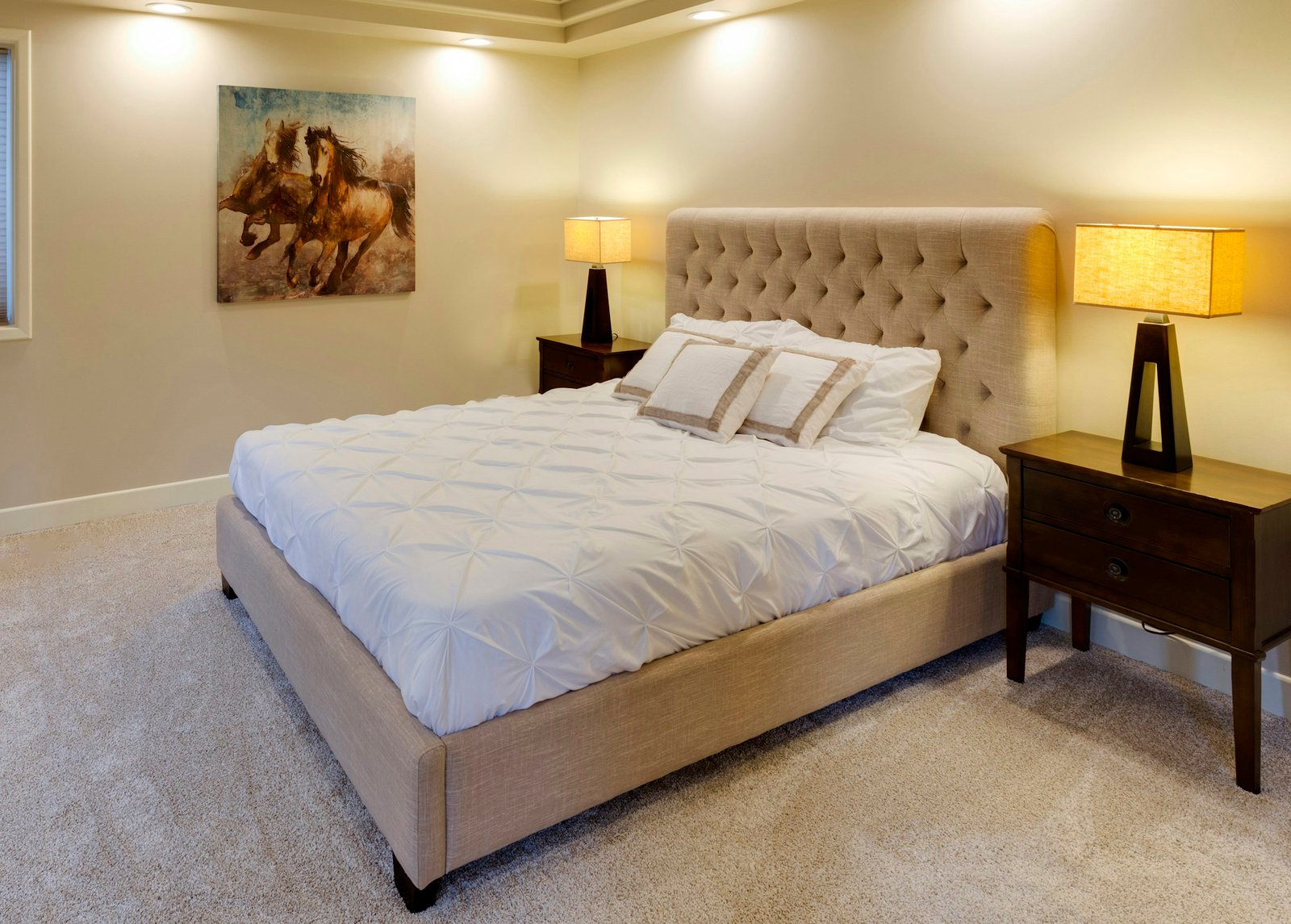 Best mattress toppers on a freshly made bed in a bright bedroom