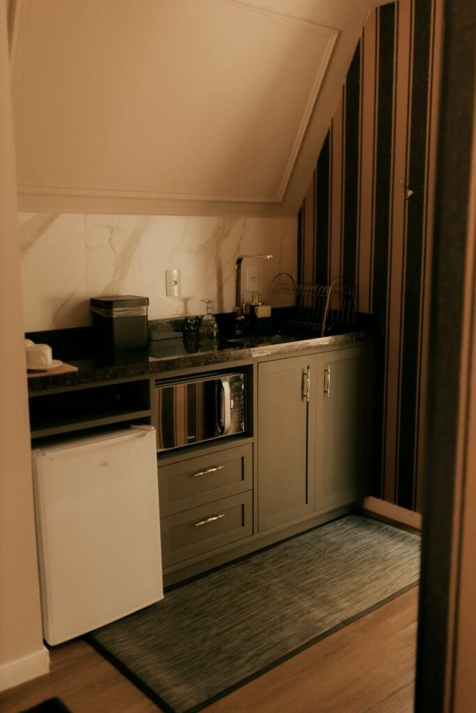 Quiet mini fridge for bedroom or studio apartment kitchenette next to a microwave cabinet