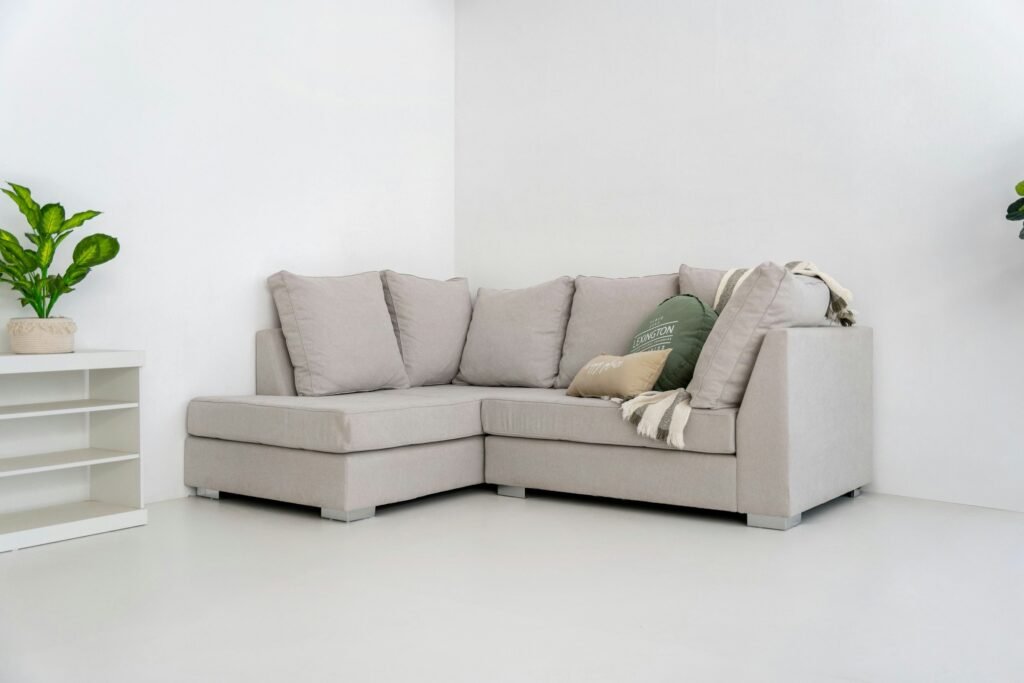 Small sectional sofa with a left-facing chaise tucked into the corner of a bright white room