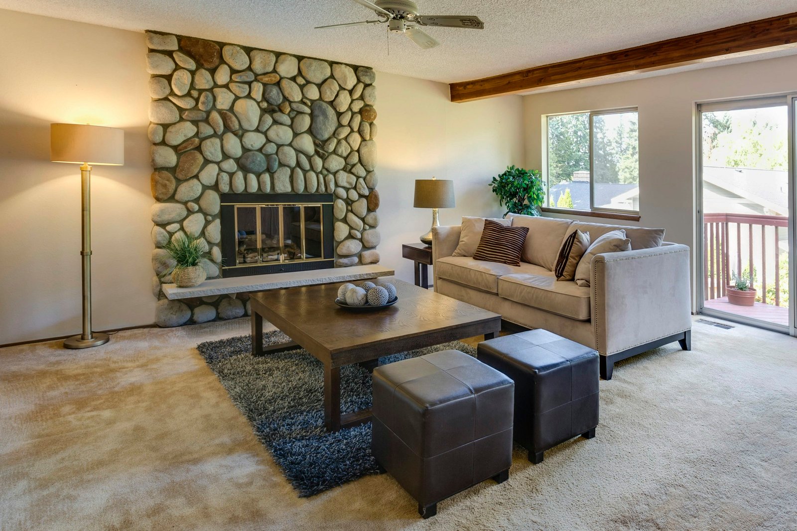 Storage ottoman cubes in faux leather in front of a coffee table and beige sofa in a bright living room