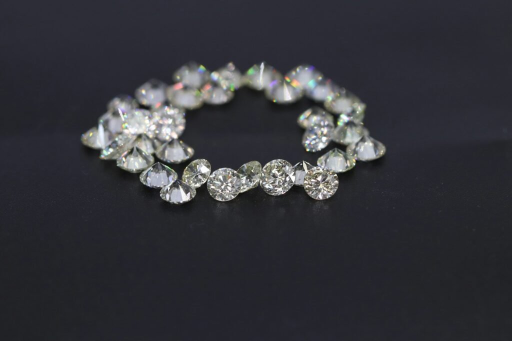 Sparkling tennis bracelet with round stones laid on a dark surface, the classic look of a moissanite or cubic zirconia tennis bracelet