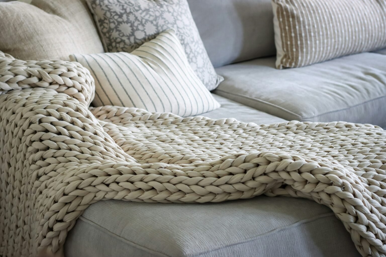 Best throw blankets draped over a sofa in a cozy living room