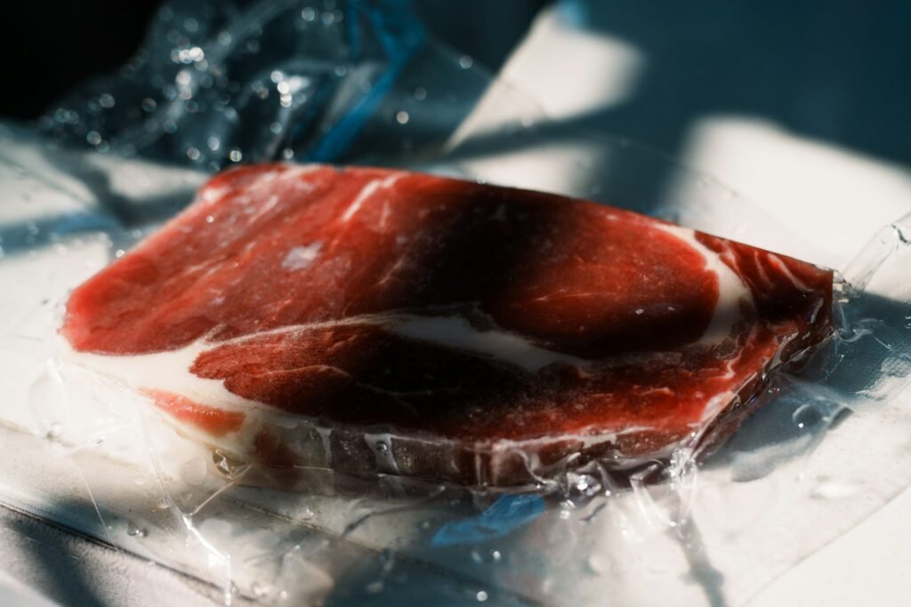best vacuum sealer for meat: a raw steak vacuum sealed in a clear bag