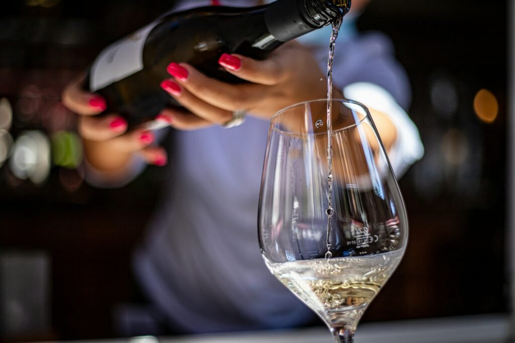 Wine aerator for white wine: white wine poured into a tall glass at a bar
