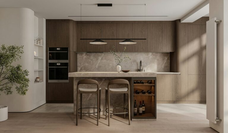 Best wine fridge ideas: a modern kitchen island with built-in under-counter wine storage beside two counter stools