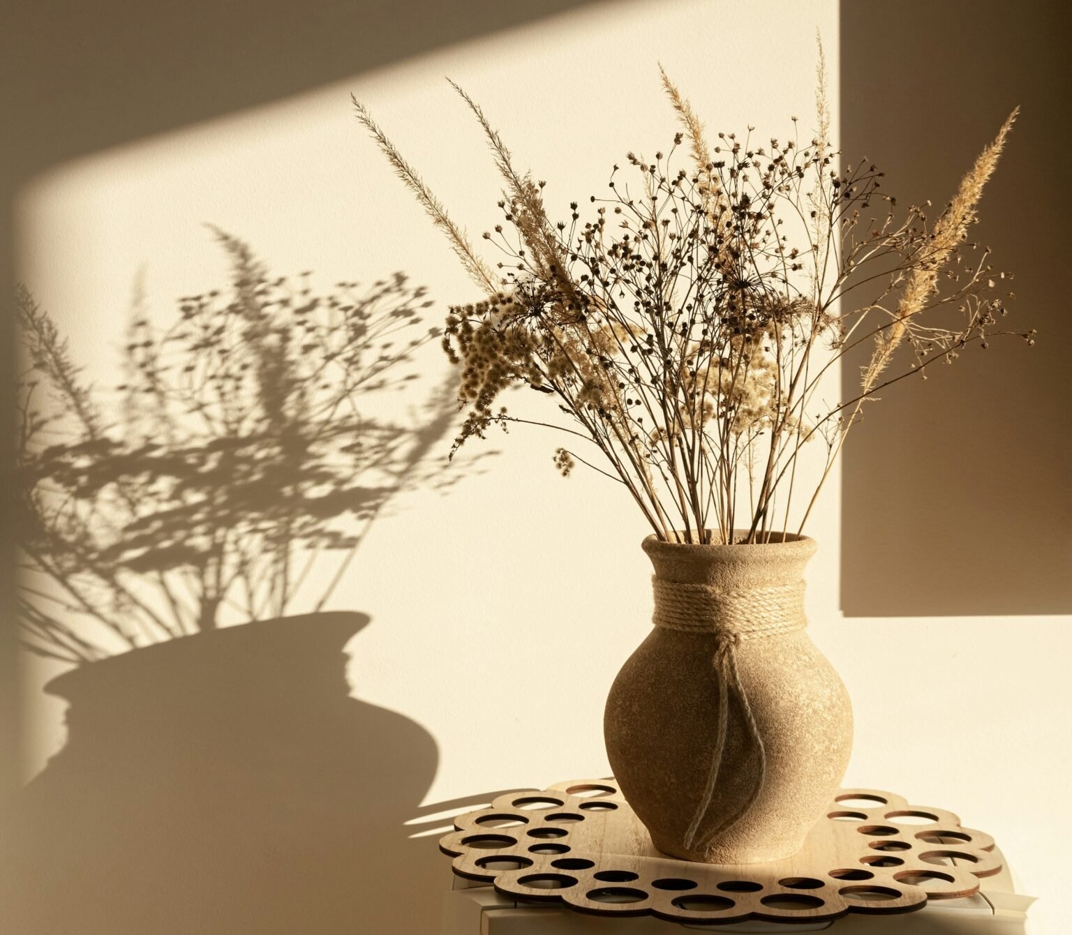 Boho dried flower bouquet style: dried stems in a brown ceramic vase