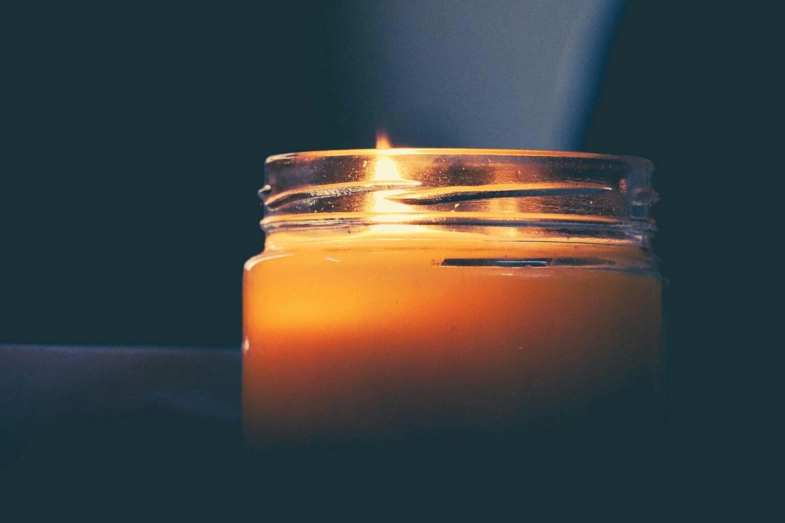 Volcano candle styling idea: a single lit candle in a calm room