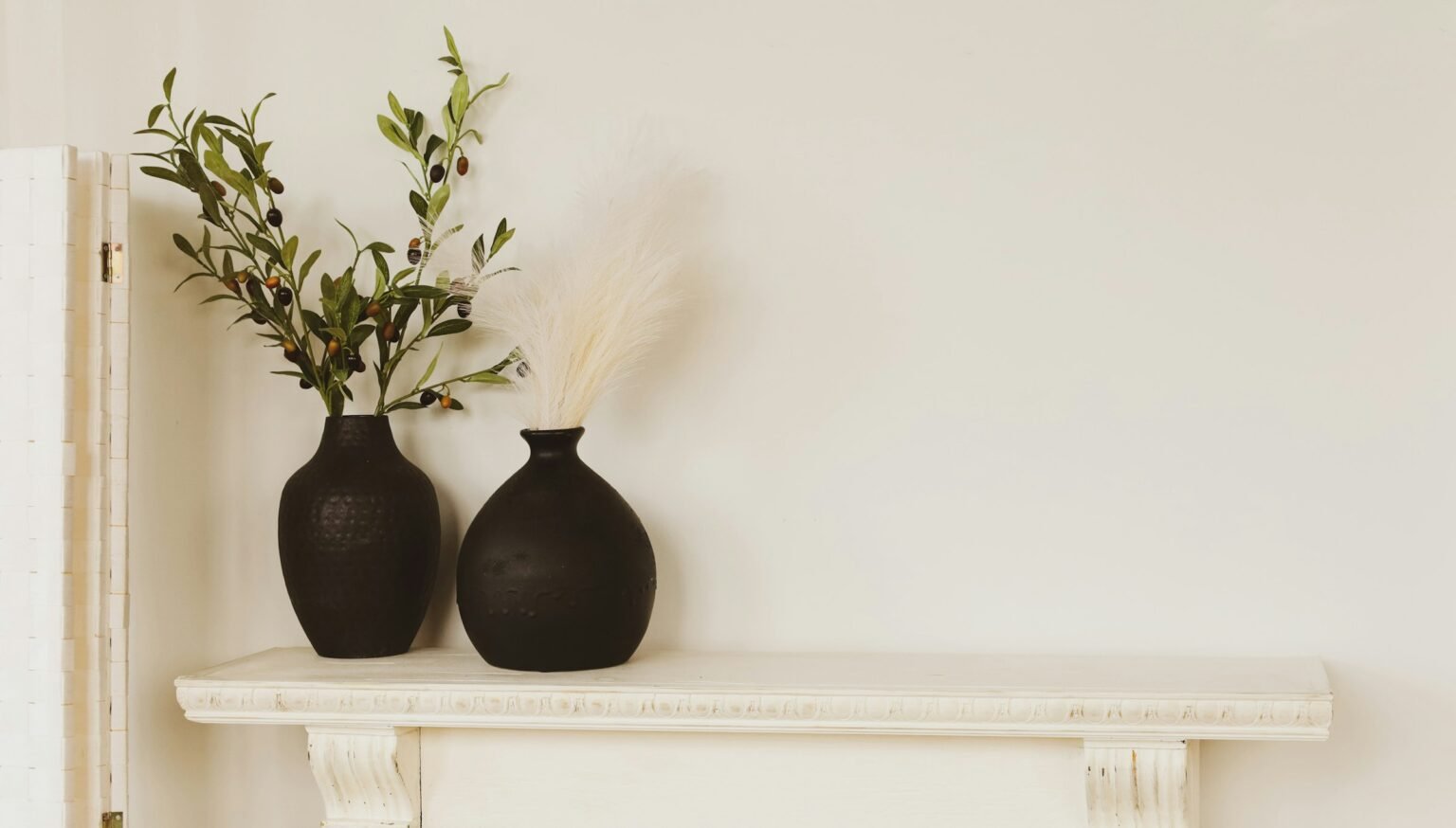 Vases on a mantel styled like a ceramic vase set