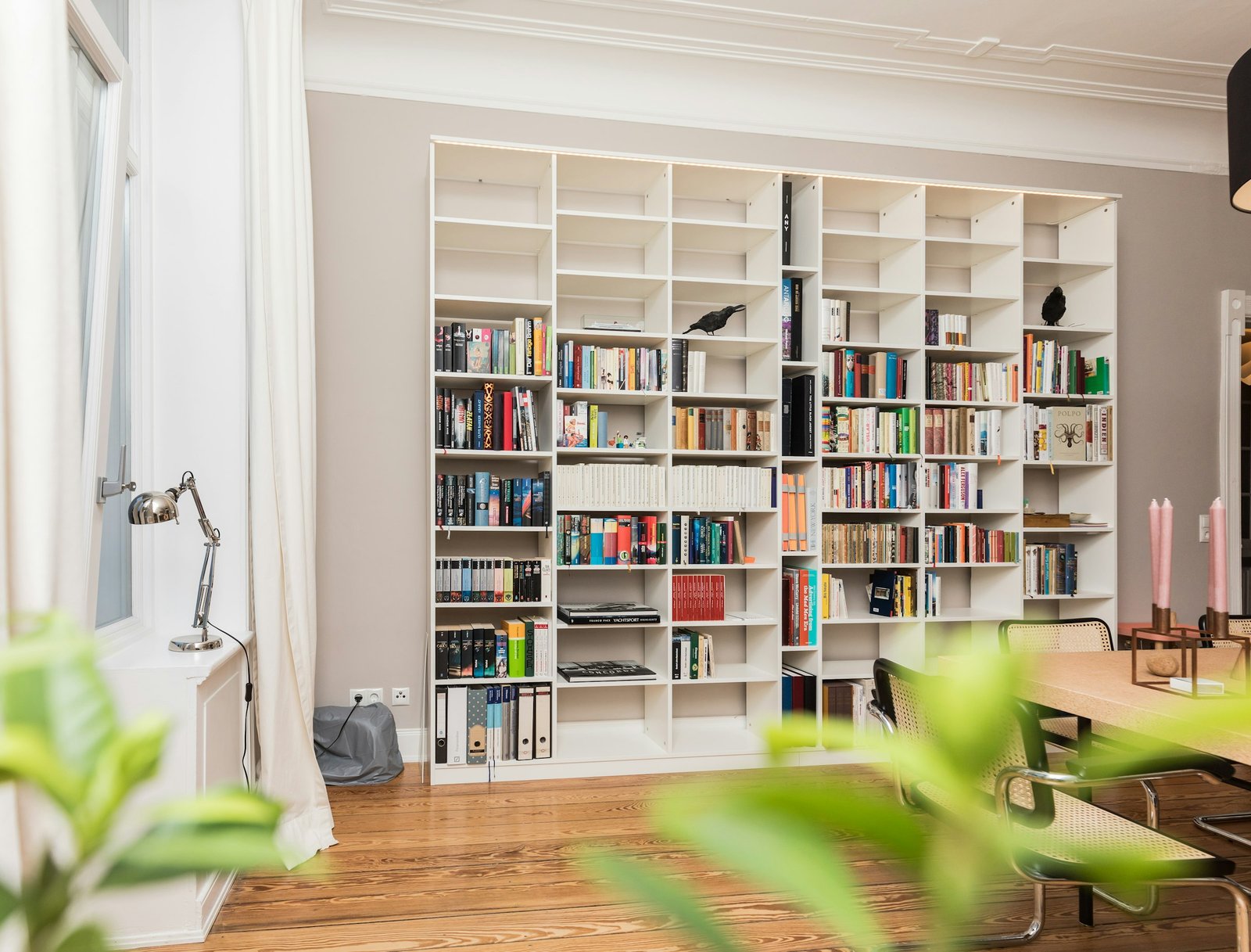 Decorative books set styled on white living room bookshelves