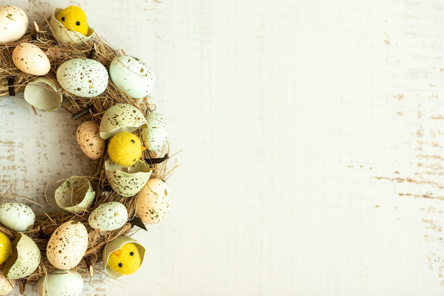 A wreath made of Easter eggs on a white background