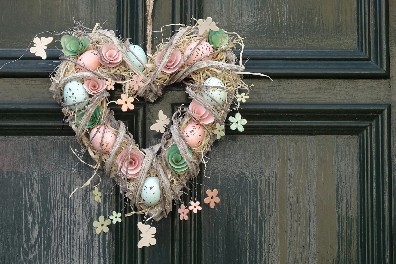 A heart-shaped spring wreath on a door