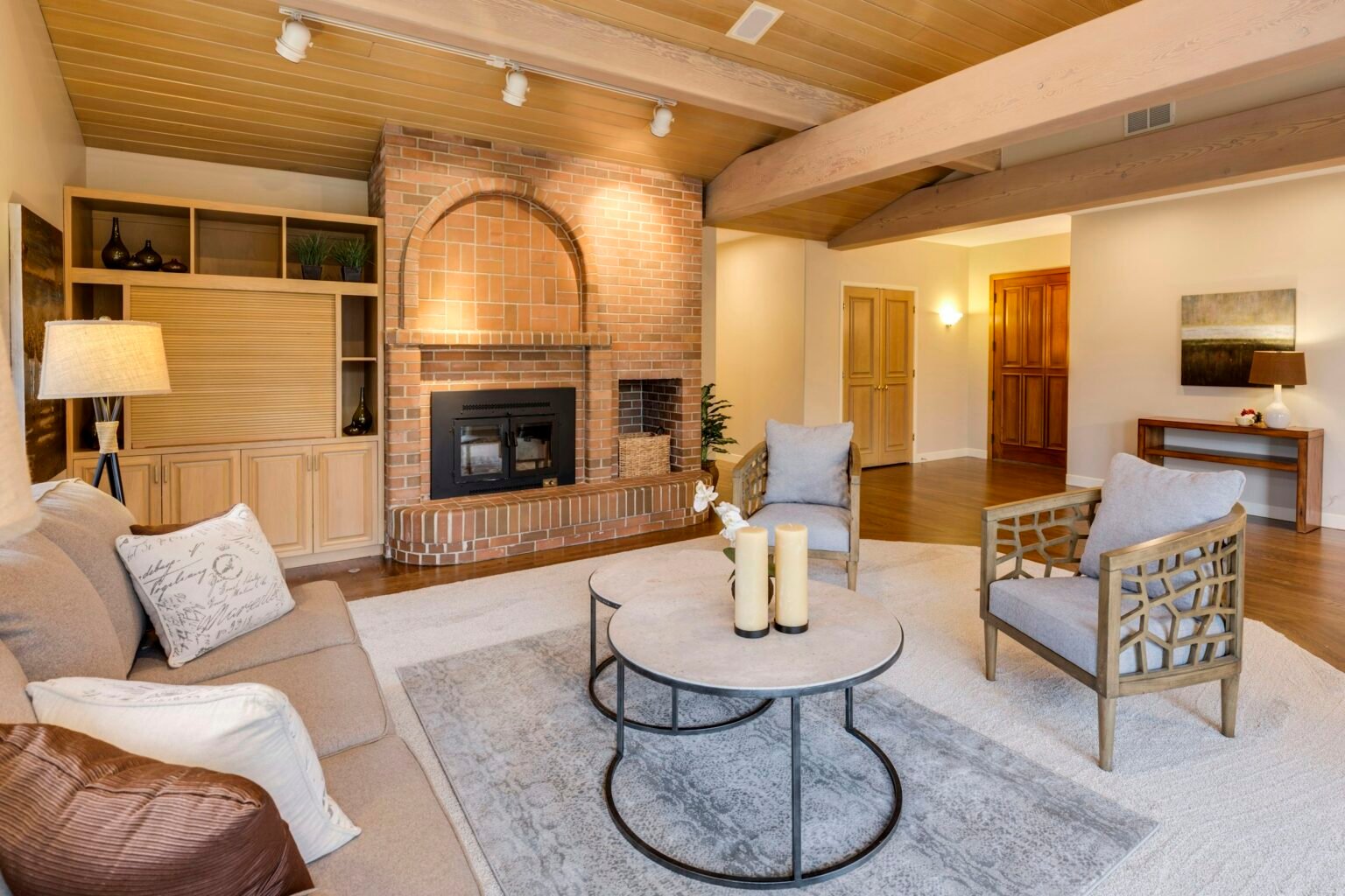 Plug in diffuser refills mood: a bright, warm living room with wood accents and a fireplace