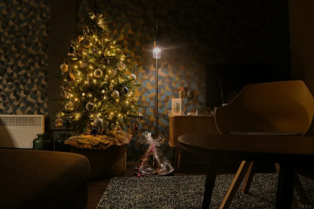 7.5 ft pre lit Christmas tree glowing with warm white lights in a cozy living room at night