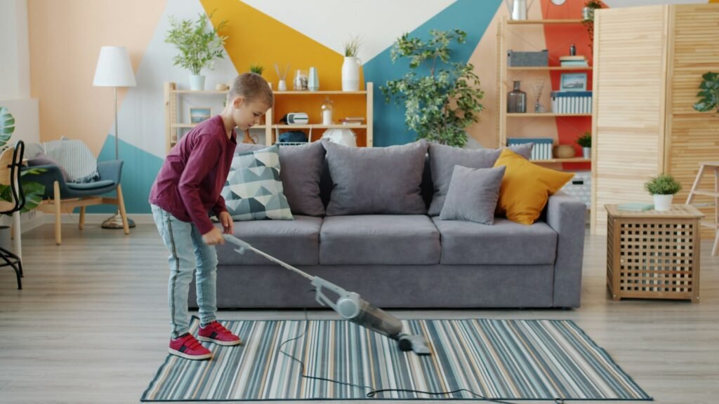 Dyson V8 run time check: a child vacuuming a striped area rug in a bright living room with a stick vacuum