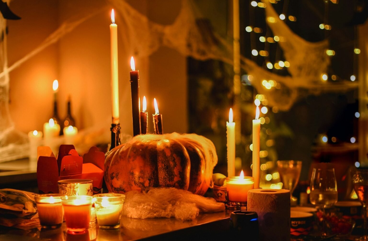 A woman setting a Halloween dinner table