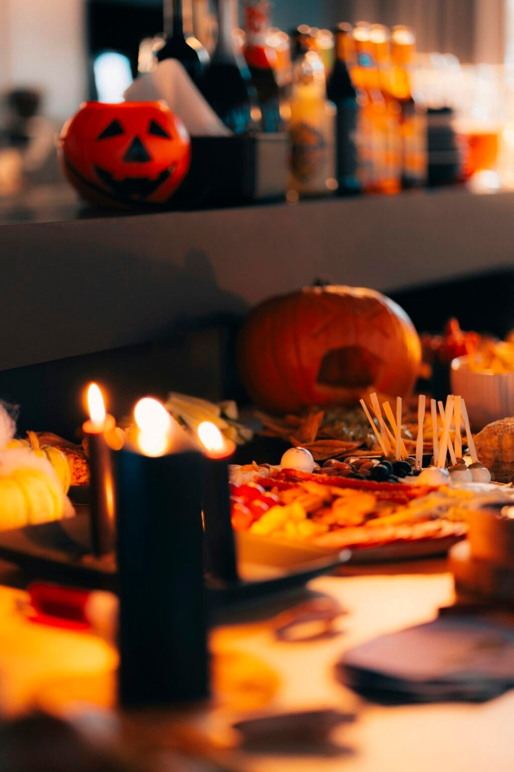 A Halloween table with food and candles