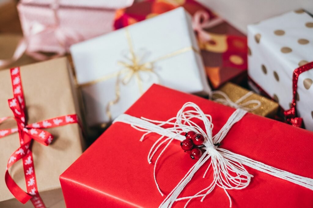 Christmas gift budget: red, kraft and polka-dot wrapped gift boxes tied with ribbon