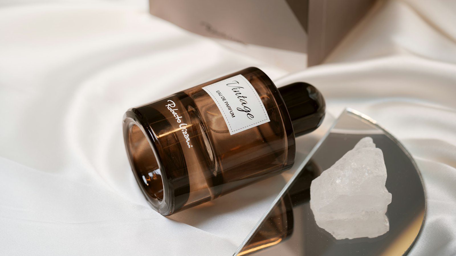 LOVERY perfume review: a brown glass eau de parfum bottle resting on white satin